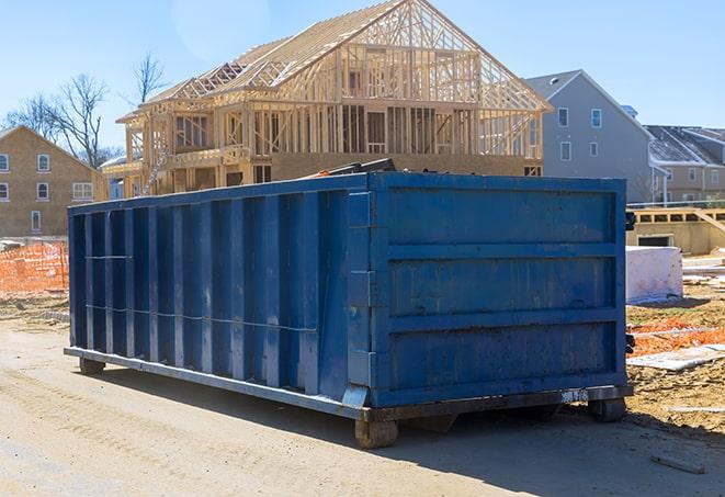 residential-sized dumpster on a driveway